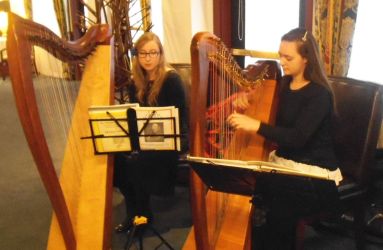 two harpists playing