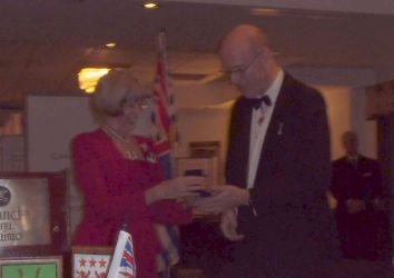 Her Honour giving John Neill a comemorative medallion