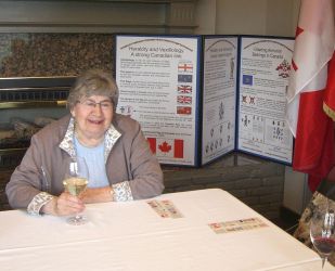 Lynn Patten sitting in front of display