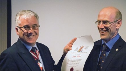 David Rumball presents certificate to John Neill