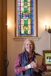 Elizabeth Roads standing in front of stained glass window