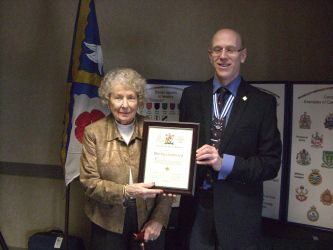 John Neill presents certificate to Shirley Greenwood