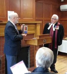 Steve presenting a plaque to Judge Pash