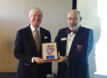 Steve Cowan presents to Sir John Cave-Browne-Cave a shield plaque