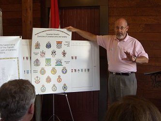 Steve Cowan showing an educational heraldic poster