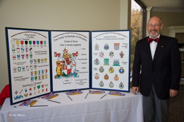 Steve Cowan standing beside his 3-panel educational display